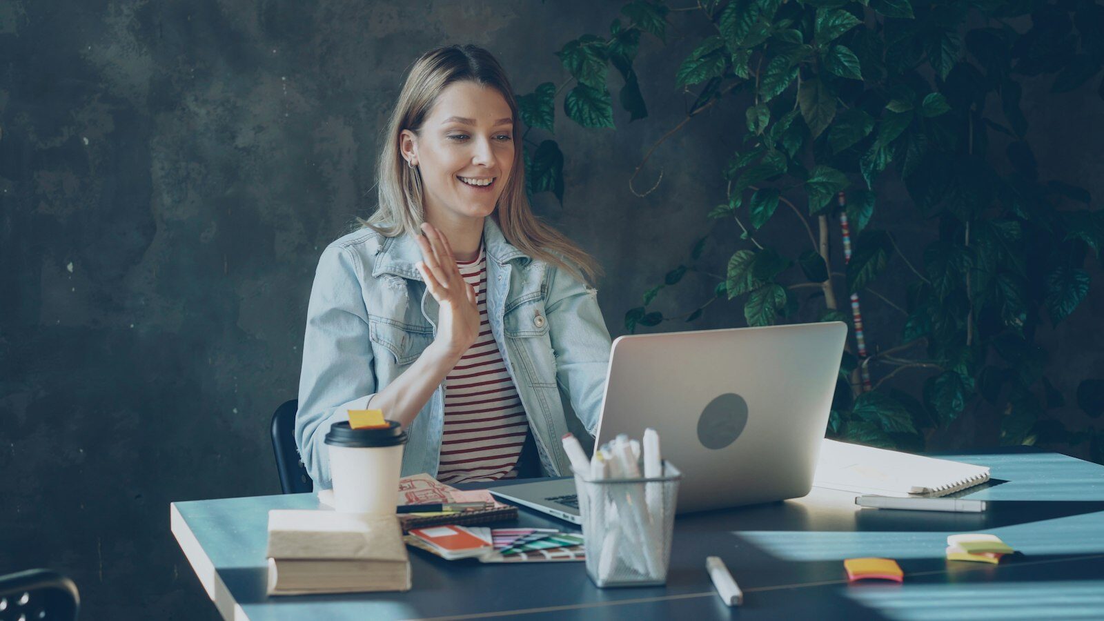 A business owner joining a live video call from her laptop