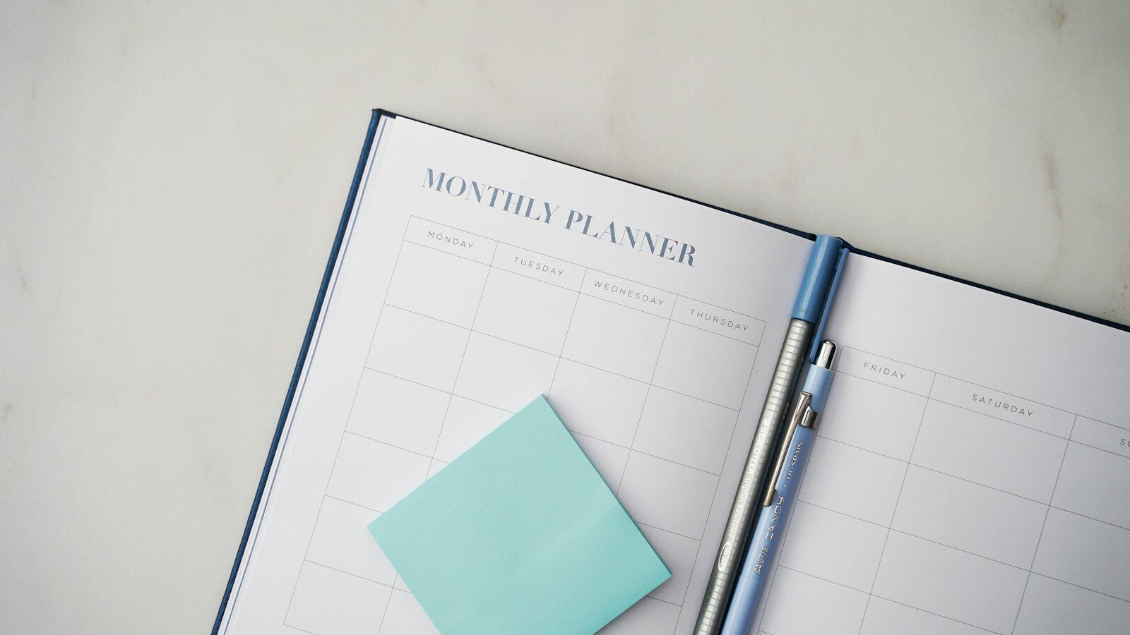 A planner with a pen resting on top of it